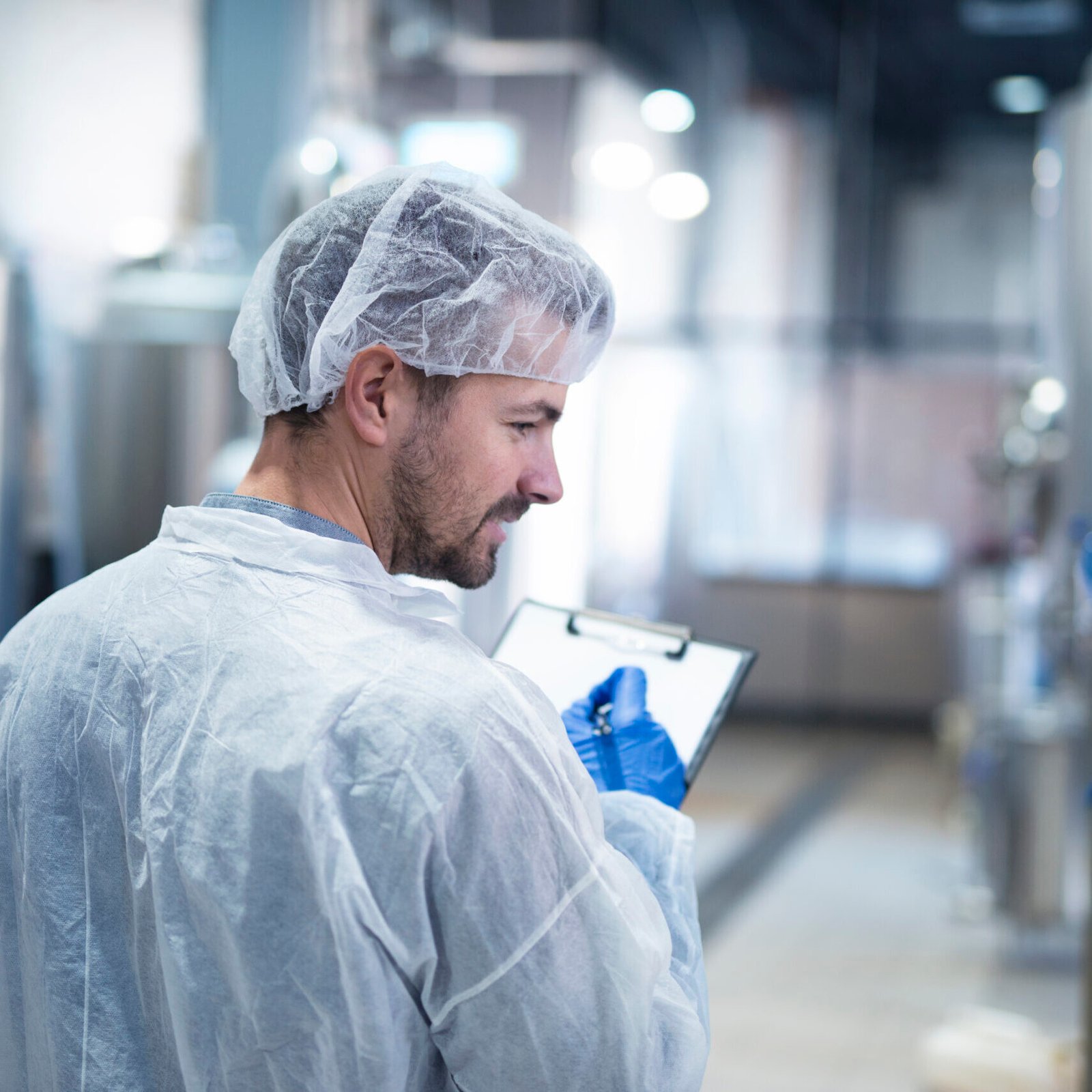 Technologist controlling production in factory.